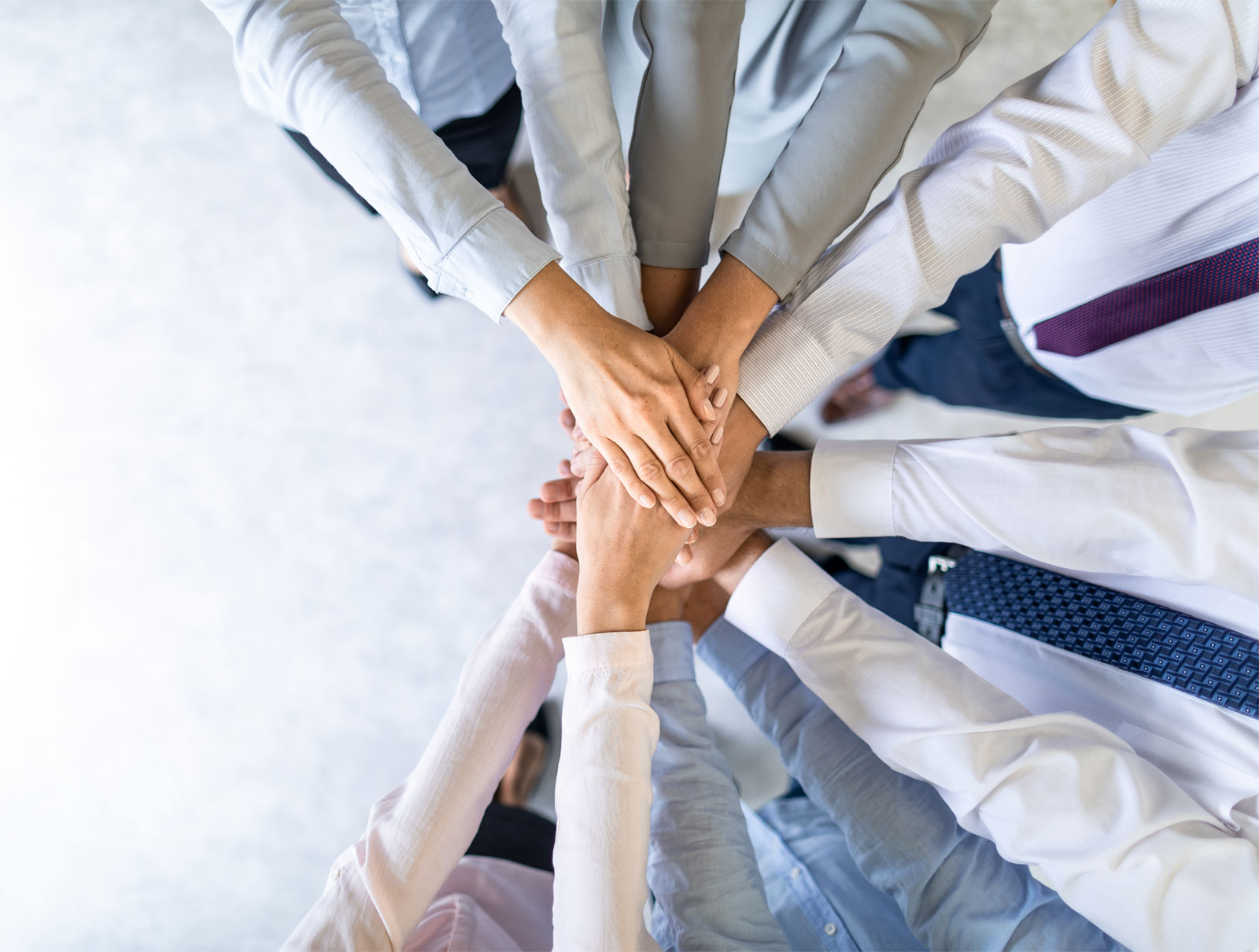 people putting hands together in the centre in solidarity