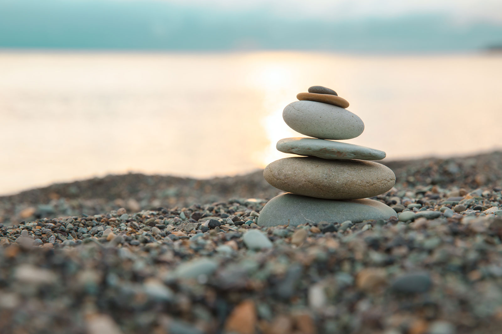 pebbles stacked on a pebbly beach - investing for growth