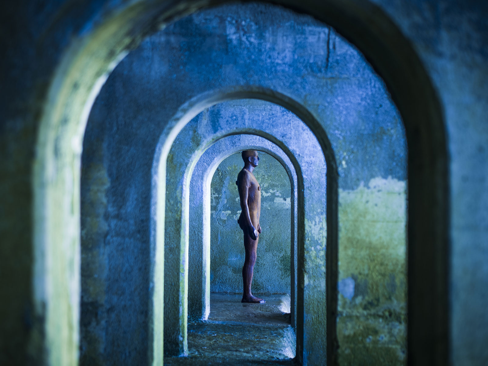 man standing between arches - About Concepts Discretionary Investments